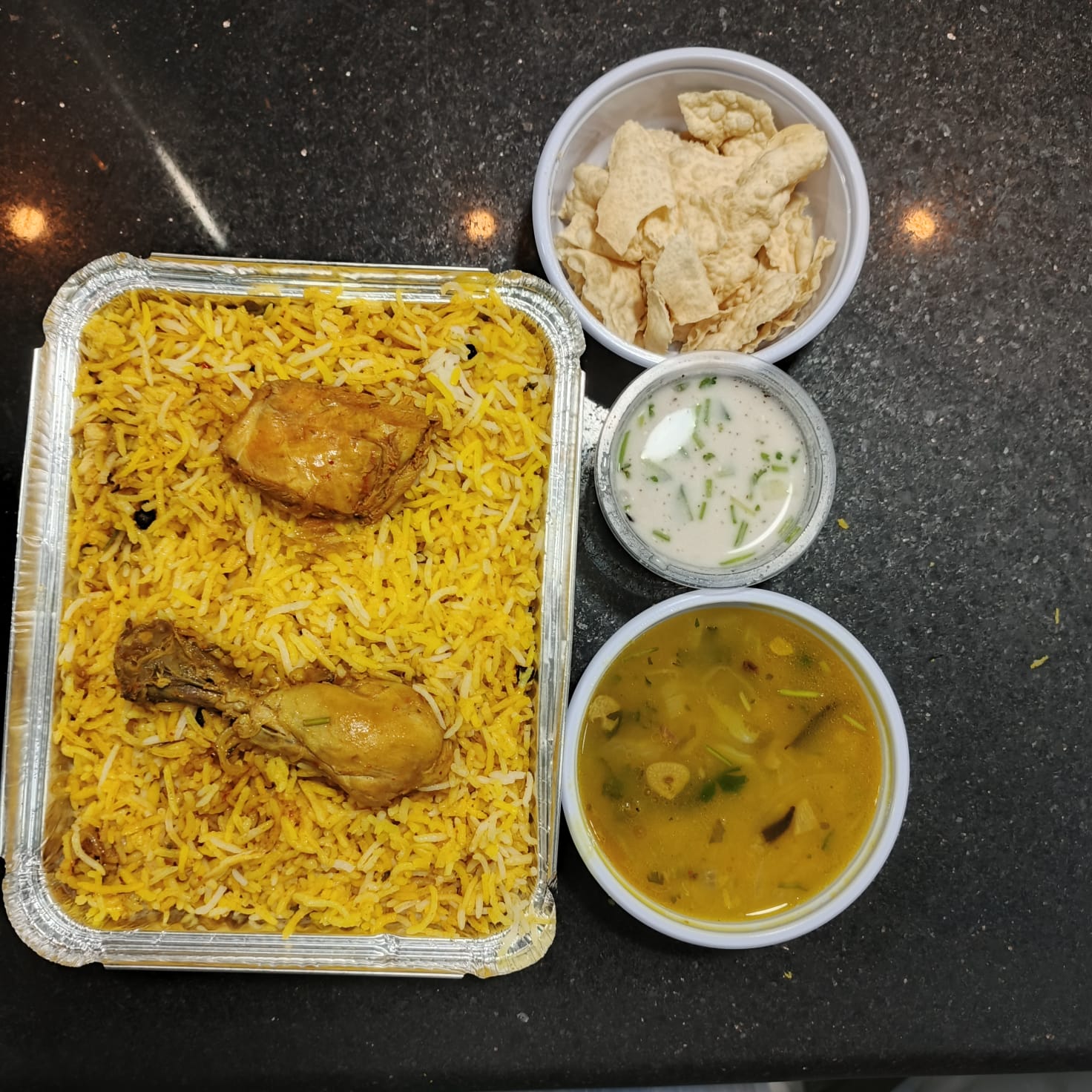 Biryani meal with sides